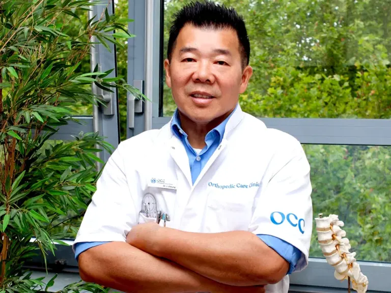 Portrait of Dr. John Cheung, orthopedic surgeon at Orthopedic Care Clinics in Amsterdam.